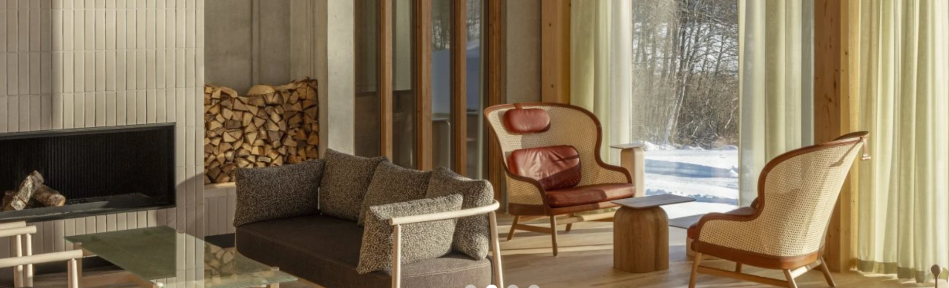 Fireplace lounge at Campus Kämpasten with winter light through tall windows